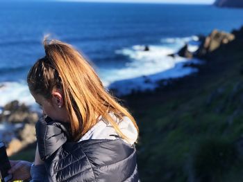 Side view of woman looking at sea