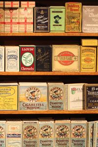 Close-up of cigarette packs on shelf at store