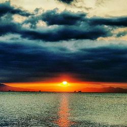 Scenic view of sea against dramatic sky