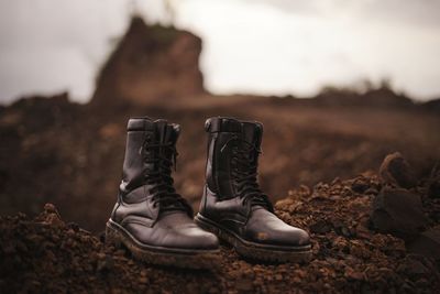 Close-up of shoes on rock