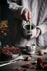 Midsection of man pouring coffee cup