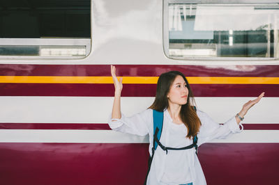 Full length of woman standing by train