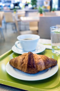 Close-up of croissant in plate on table