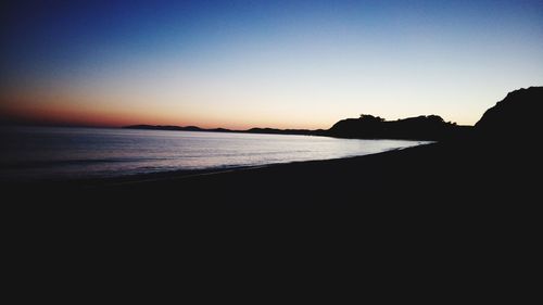 Scenic view of sea against clear sky at sunset