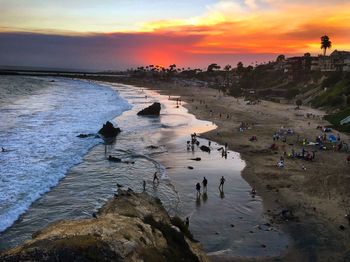 People on beach during sunset