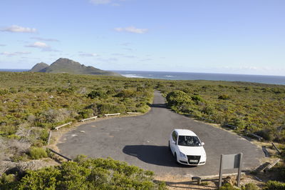 High angle view of car in parking lot amidst green landscape