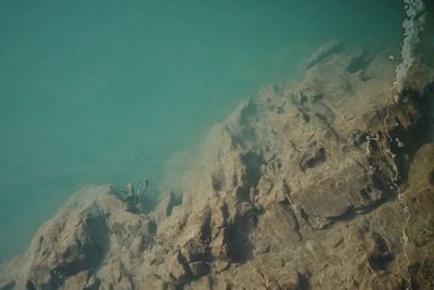 High angle view of rock formations in sea