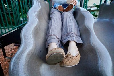 Low section of man sitting outdoors