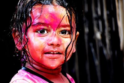 Coloured face of a cute baby at the time of holi, a festival of colours