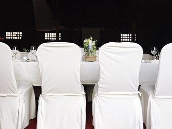 Chairs and table arranged at wedding reception