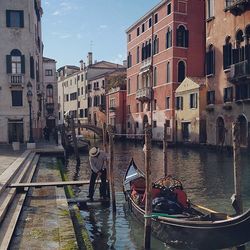 Boats in canal with buildings in background