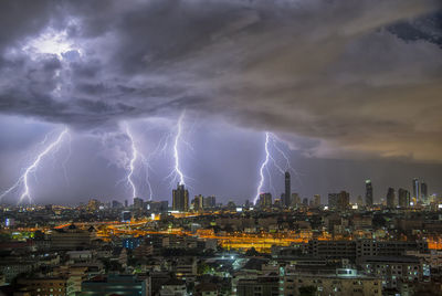 Lightning over buildings in city at night