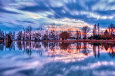 Scenic view of lake against sky at sunset