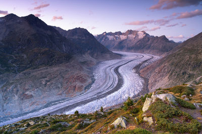 Scenic view of river amidst mountains against sky