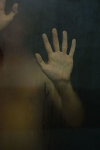 Close-up of hand on glass