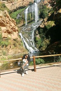 Woman in waterfall