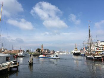 Sailboats moored in harbor