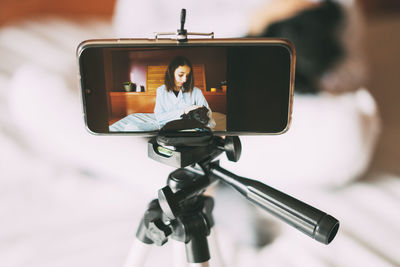 Veterinary surgeon filming a video at home.