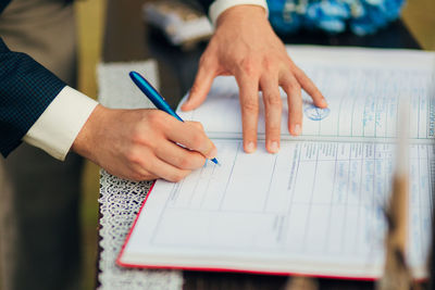 Man signing on register at wedding