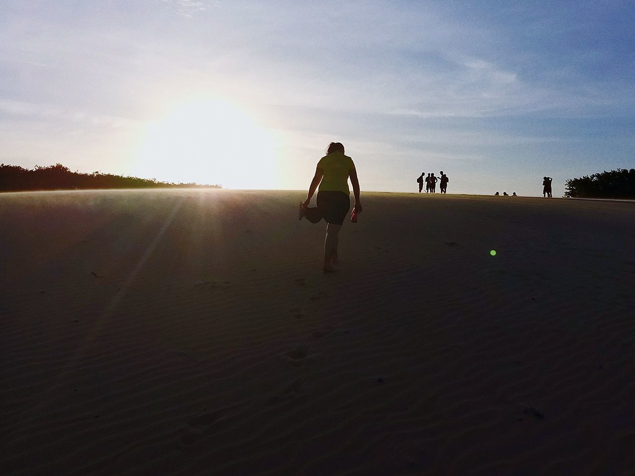 SILHOUETTE WOMAN ON SAND AT BEACH AGAINST SKY