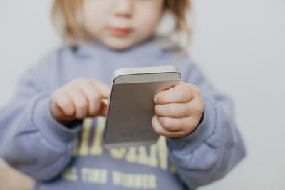 Midsection of woman holding mobile phone