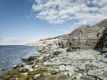 Rocks on beach against sky