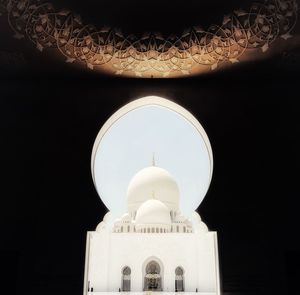 Low angle view of illuminated building against sky at night