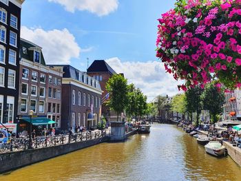 Canal amidst buildings against sky