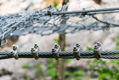 Stainless steel rope and bow rope clamps stretched between the rocks. technique is used in industry, 