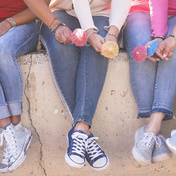 Low section of friends sitting outdoors