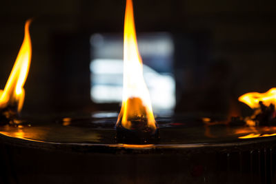 Fire from candles lantern in temple, close up of candle flame