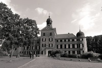 Low angle view of historical building against cloudy sky