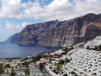 Aerial view of town by sea and mountains