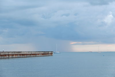 Pier over sea against sky