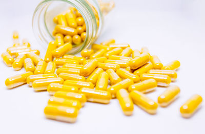 High angle view of yellow and fork on white background