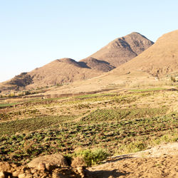 Scenic view of landscape and mountains against clear sky