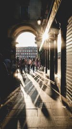 People in illuminated corridor