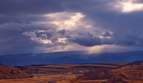 The rays of the sun through the clouds on a day with strong wind and snow