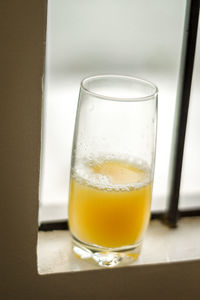 High angle view of juice in glass on window sill