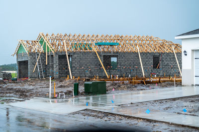 Construction site by building against clear sky