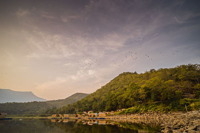 Tropical lake and mountains. small bamboo traditional cottage next the lake in sukhothai thailand