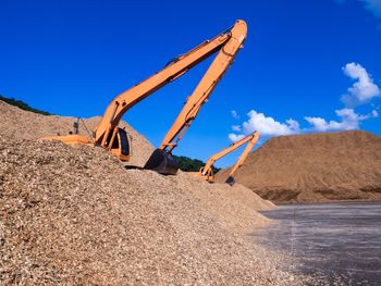 Low angle view of sand against clear blue sky