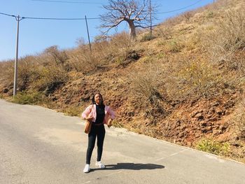 Portrait of woman standing on road