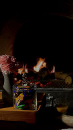 Close-up of burning candles on glass table