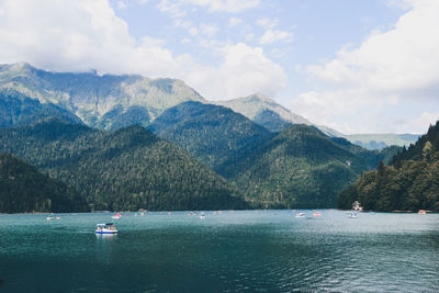 Scenic view of sea and mountains against sky