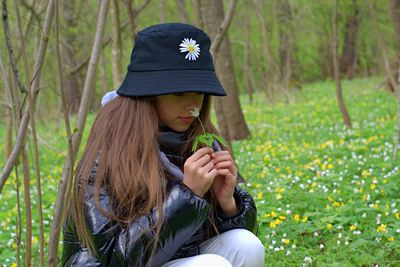 Low section of woman wearing hat on field