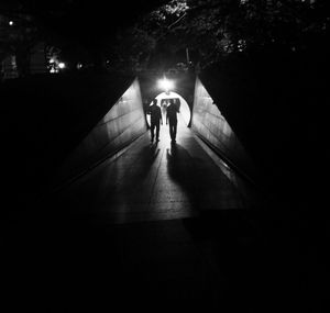 Blurred motion of people walking in tunnel