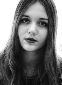 Close-up portrait of beautiful young woman over white background