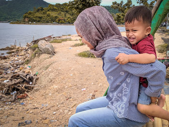 Side view of woman piggybacking son