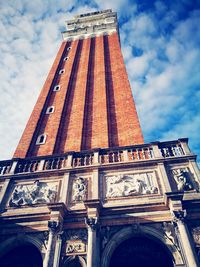 Low angle view of historical building against cloudy sky